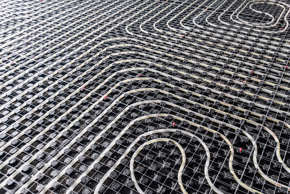 Black underfloor heating posed in a underconstruction building